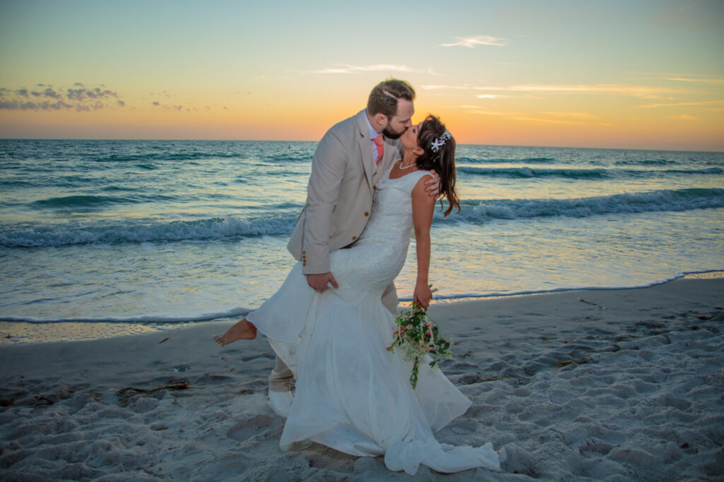 bride and groom on the beach at sunset