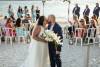 bride and groom kissing as they exit their beach wedding ceremony