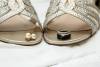 brides jewelry sitting on the tip of her shoes