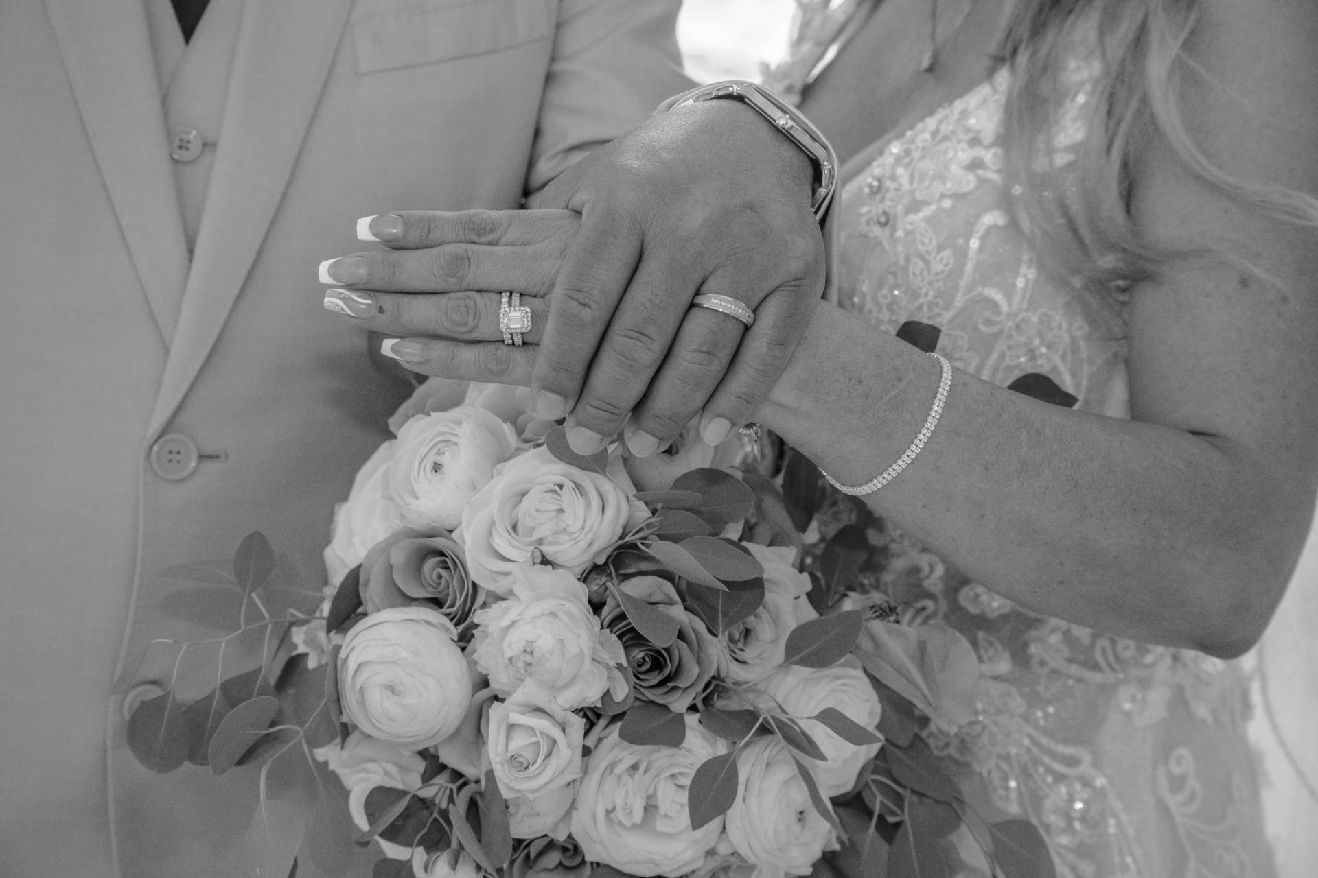 bride and grooms wedding ring hands