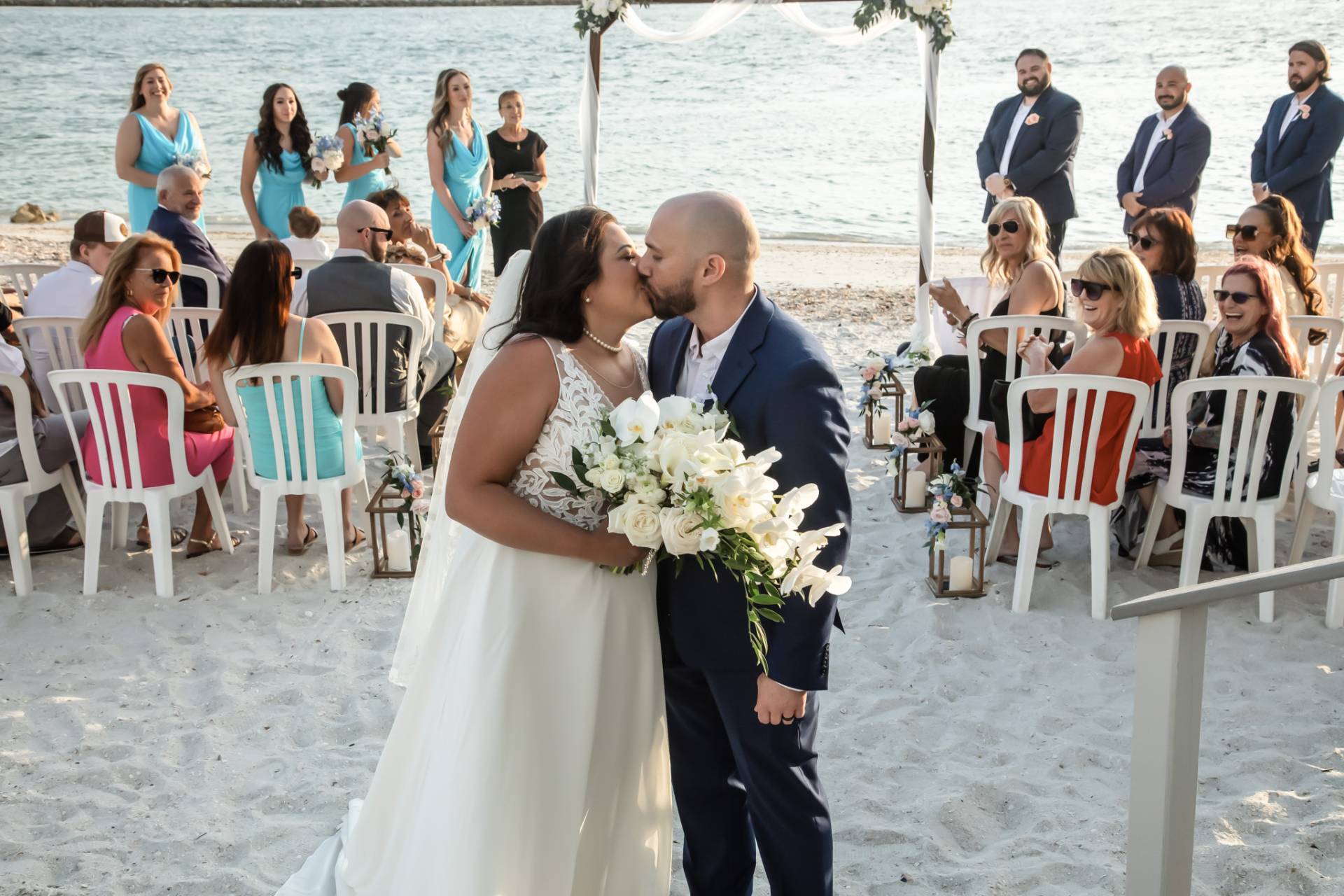 bride and groom kissing as they exit their beach wedding ceremony
