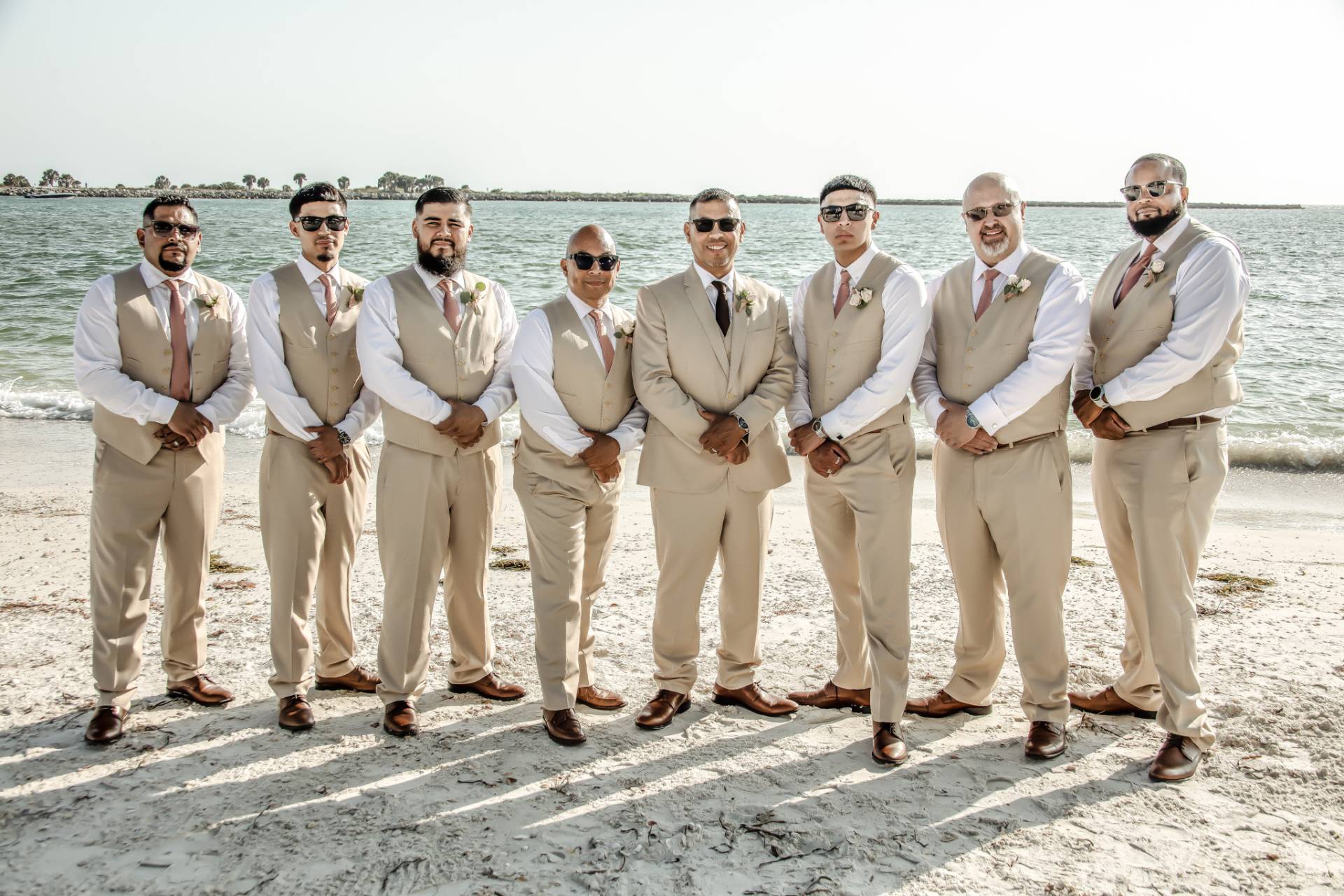 groom with groomsmen on the beach